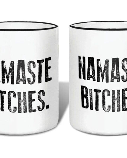 Two white mugs with black handles and 'Namaste Bitches' text on a white background