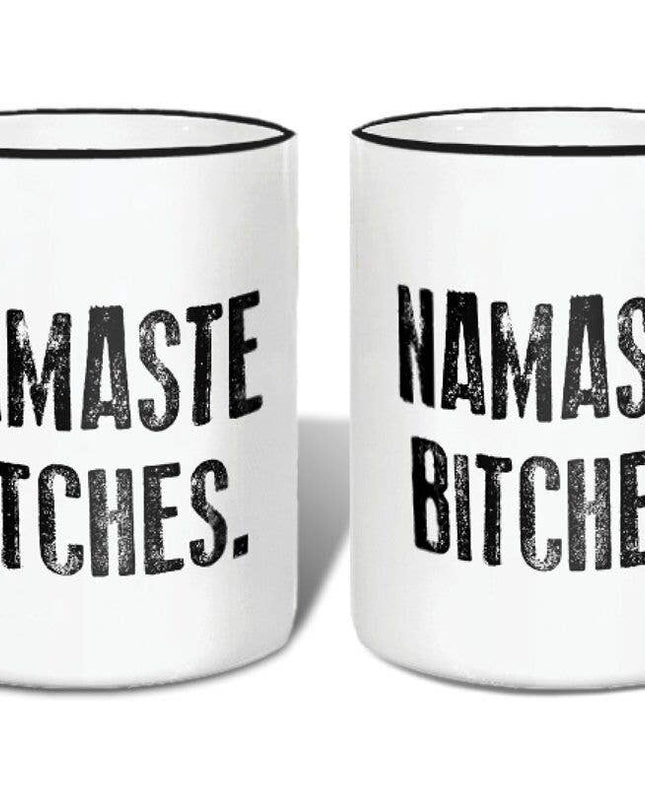 Two white mugs with black handles and 'Namaste Bitches' text on a white background