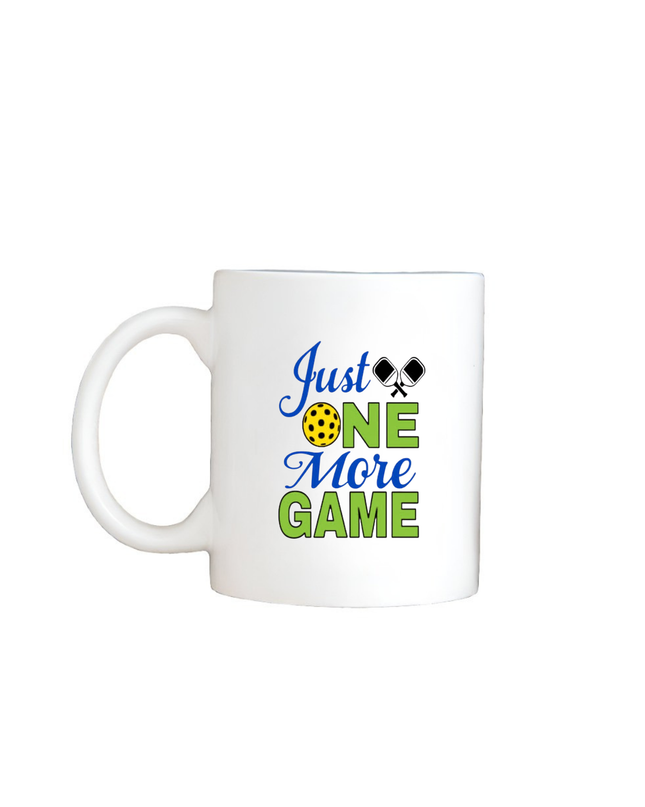 White mug with 'Just One More Game' text and tennis graphics on a white background