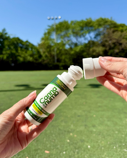 Two bottles of Canna Nudo product held by hands with a green outdoor background