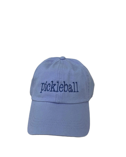 Blue cap with 'pickleball' text on a wooden surface