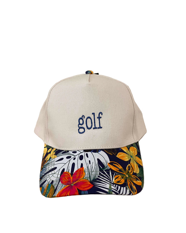 Cap with 'golf' text and colorful floral pattern on a wooden surface