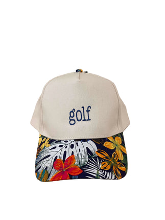 Cap with 'golf' text and colorful floral pattern on a wooden surface