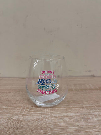 Clear glass with text on a wooden surface and beige background